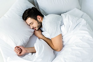 a person sleeping after figuring out what strain of weed helps them sleep better