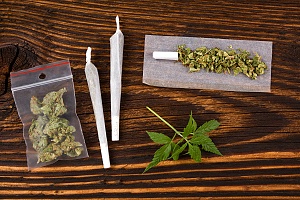 rolled joints and other cannabis nuggets on a table that are fresh from a dispensary