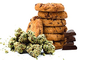 weed cookies are shown in a stack with cannabis buds around them