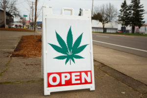 cannabis shop that sells edibles put out sign that conveys they are open