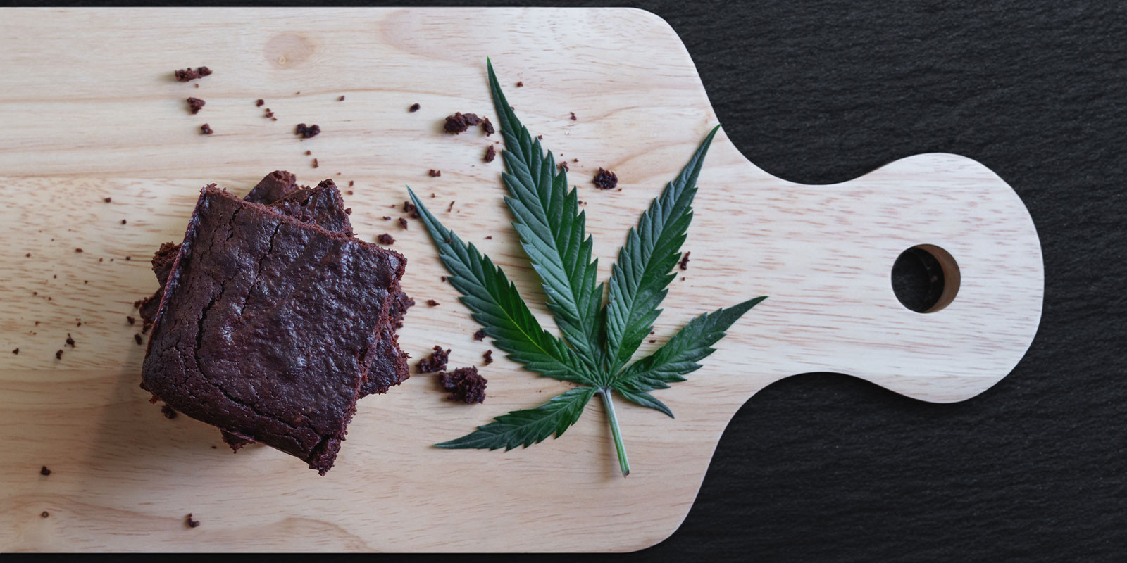 Cannabis Edibles on cutting board with weed plant