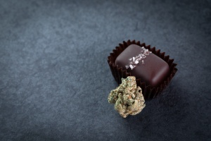 Cannabis Edibles laying on table with flower and chocolate