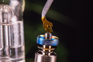 macro detail of dabbing tool with small piece of cannabis oil
