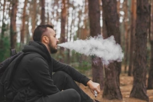 man vaping in the forest