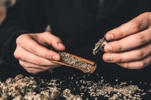 man preparing weed for different types of weed highs