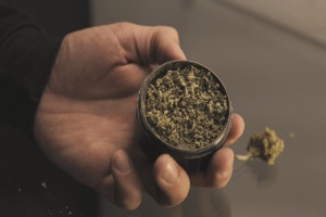 person using a weed grinder