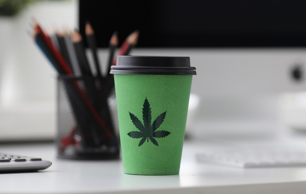 coffee cup with cannabis logo on office