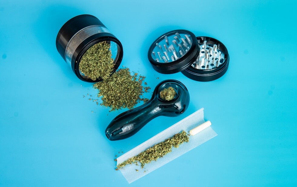 ground marijuana buds on a metal grinder
