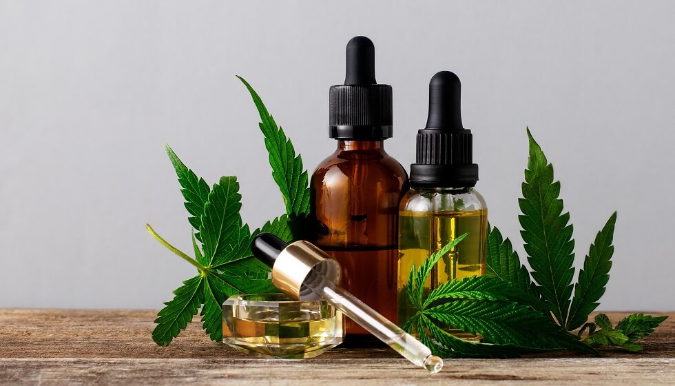 Boston cannabis oil in bottles on gray background with copy space