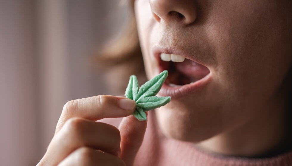Boston, MA woman eating edible cannabis leaf for anxiety treatment