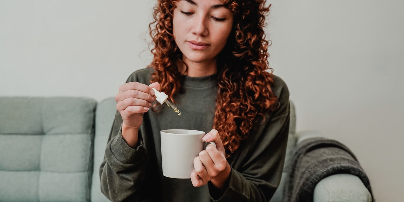 Boston woman taking cannabis oil in tea cup