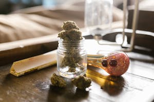 A Jar of Cannabis and Pipe on Table in Boston, MA