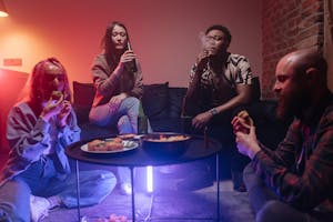 Girls and Boys Tasting Cannabis Edibles in Party