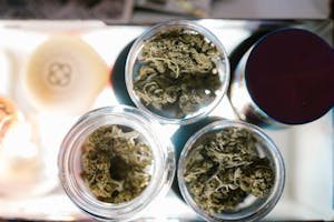 Green Cannabis Edibles in Clear Glass Containers